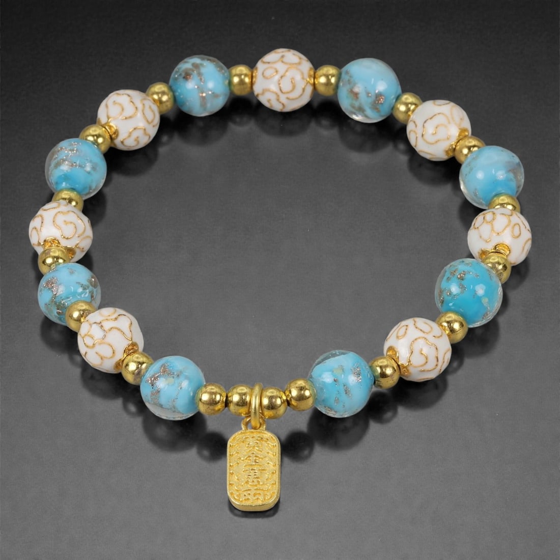 A Chinese Cloisonne Enamel Bracelet, 20th-21st Century, 90YB: Constructed as a circular bracelet composed of alternating spherical cloisonne enamel beads and small gilt metal spacers. The beads are decorated with opaque white and turquoise-blue enamel grounds, s