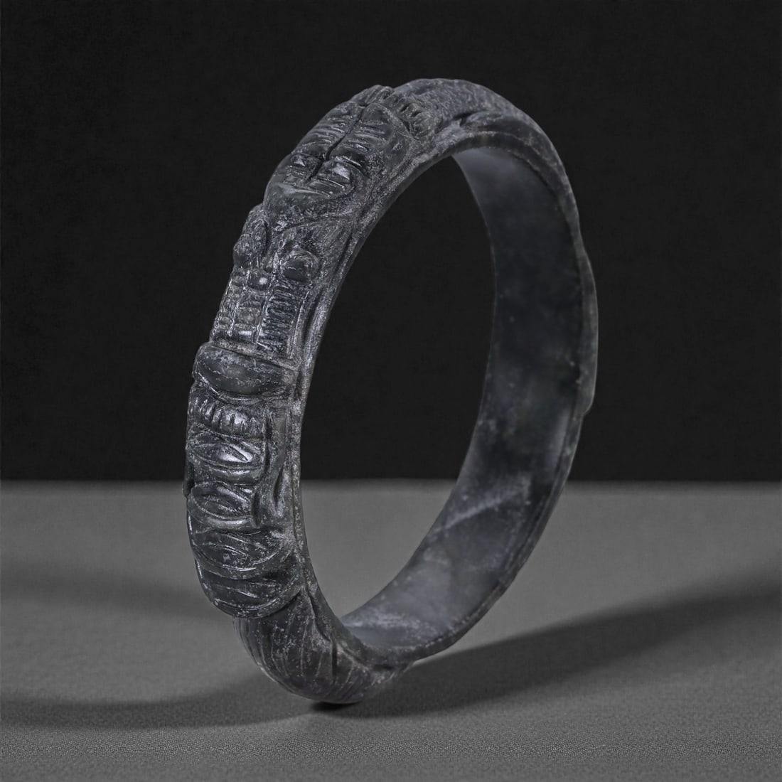Jadeite Jade Dragon Bracelet - Carved Asian Bangle, 6.3cm Inner Diameter, 29WE: Carved from dense grey-green jadeite, this bracelet is formed as a continuous circular bangle with sculptural relief carving along the exterior surface. The stone has been hollowed and shaped through