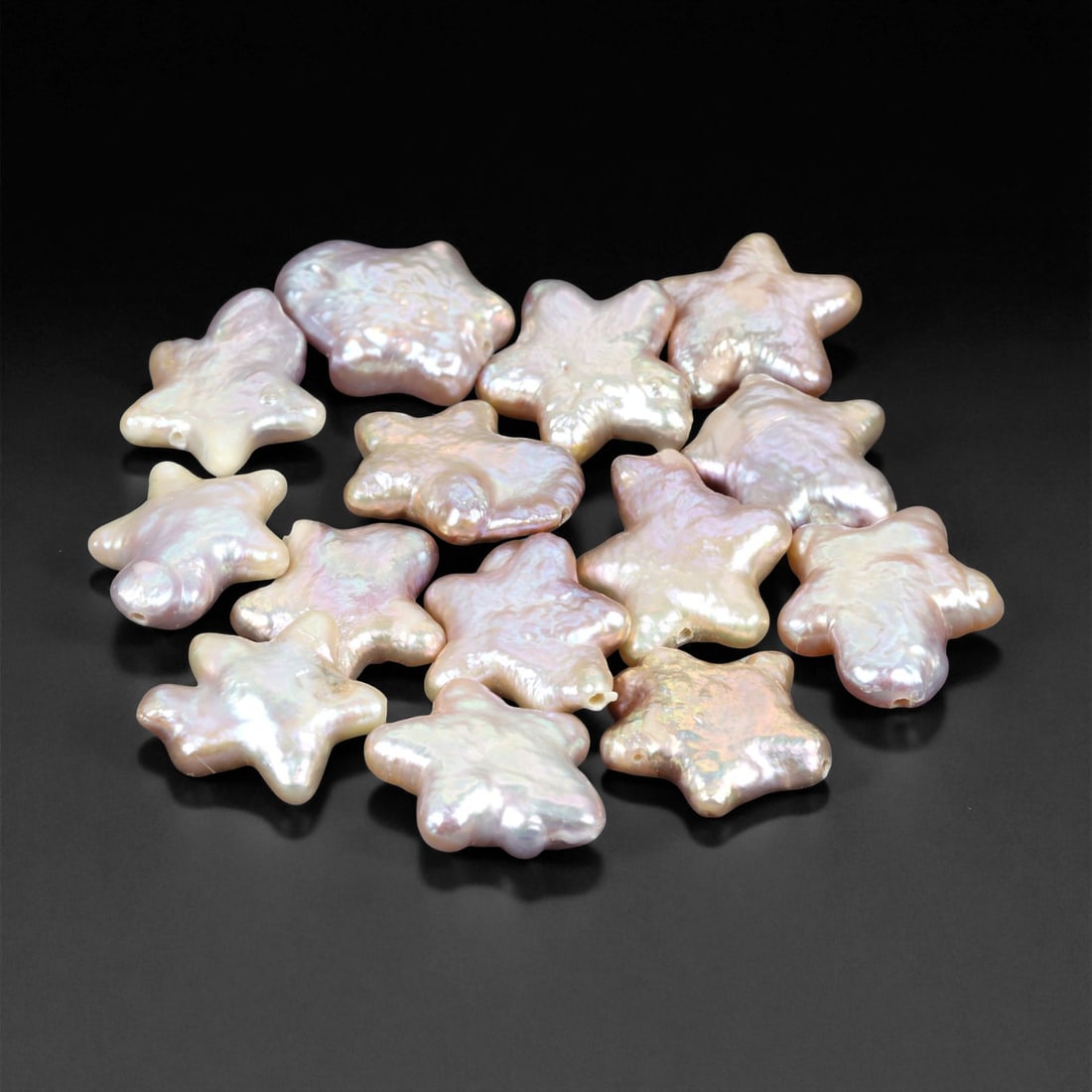 1.1 - 1.8 cm Star-Shaped Freshwater Pearl Parcel - Natural Iridescent Lot, 83XE: This delightful parcel of freshwater pearls showcases a whimsical array of star-shaped forms, each measuring between 1.1 and 1.8 cm. With soft pastel hues of rose, ivory, and lavender, these pearls ex