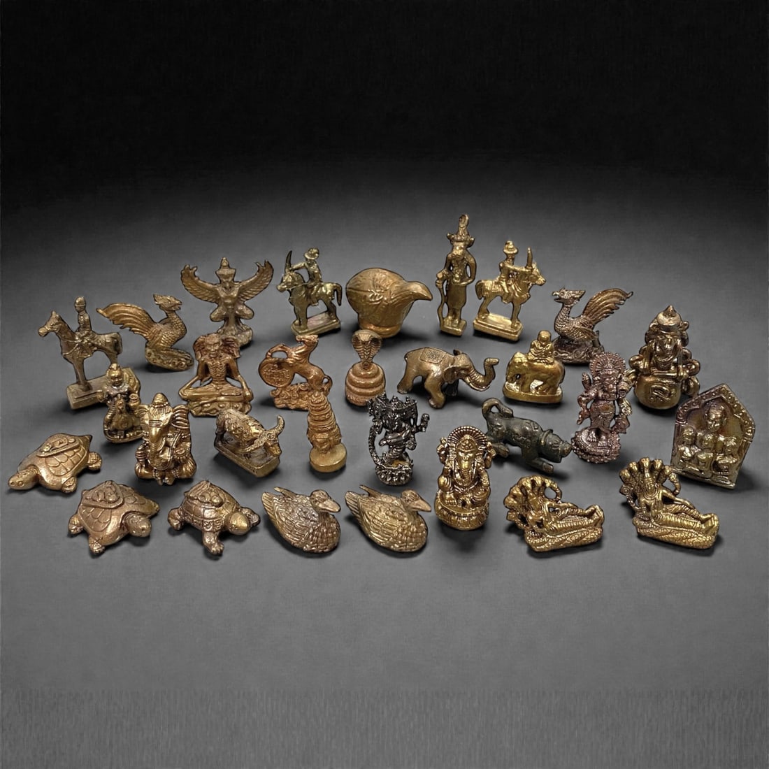 A Group of Thai Copper Alloy Figurines, 20th Century, 5W: Comprising thirty small figurines cast in copper alloy with varied brown to golden patination, the group represents a wide range of figural, zoomorphic, and mythological subjects associated with Thai