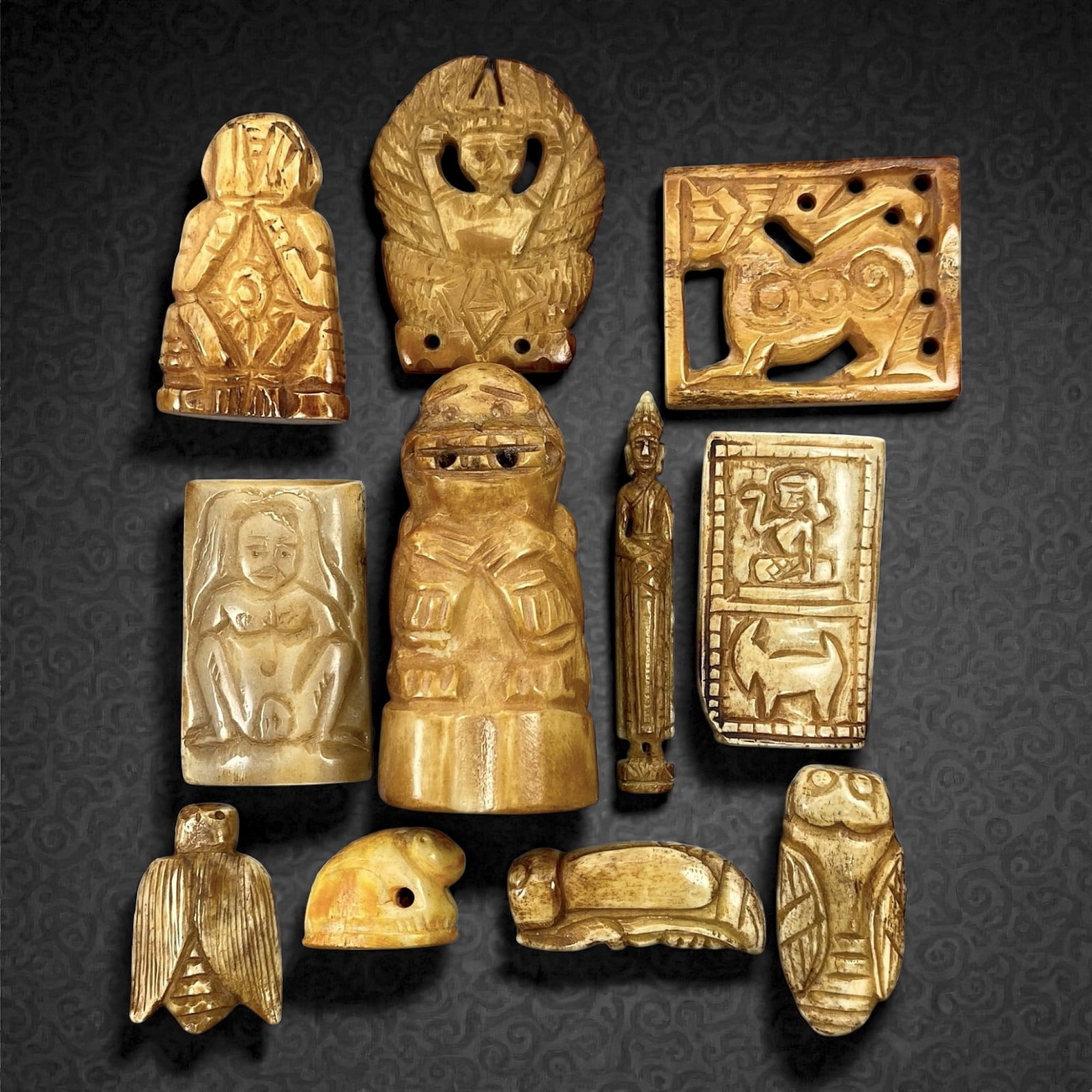 A Group of Thai Bone Amulets and Relief Carvings, 20th Century, 77V: Comprising eleven carved bone objects of varying forms and iconography, worked from pale to honey-toned bone with natural tonal variation and visible grain. The group includes figural amulets, zoomorp