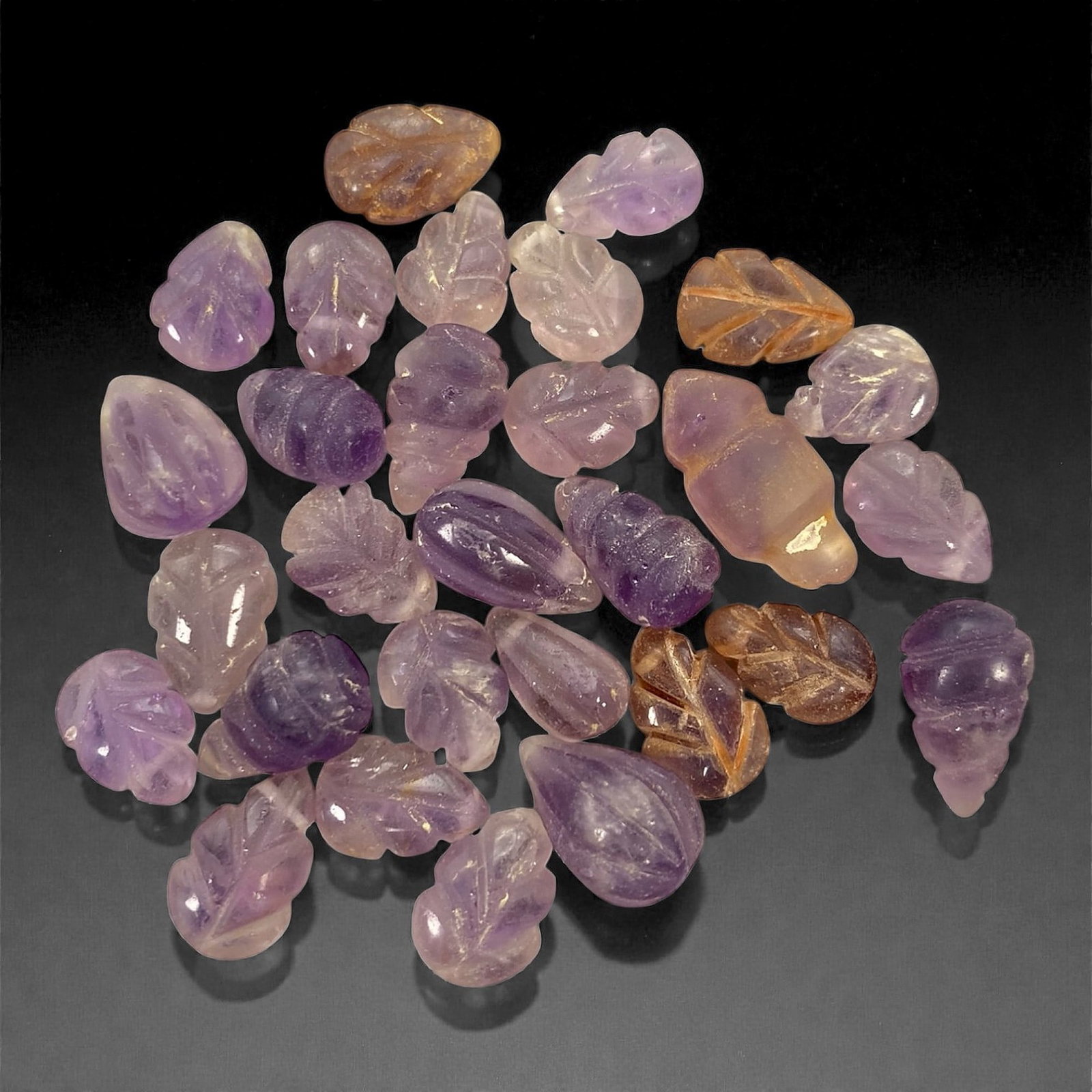 A Group of Medieval Amethyst Beads, Circa 12th-14th Century, 92V: Comprising twenty-nine amethyst beads carved from translucent purple quartz with natural tonal variation ranging from pale lilac to deeper violet, some exhibiting areas of lighter zoning and minor inc