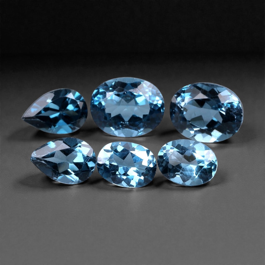 14.04 Carats London Blue Topaz Lot - Natural Brazilian Stones 7-10mm, 64XH: This richly saturated lot of London blue topaz offers a dramatic depth of color-an elegant blend of inky teal and stormy blue tones that set it apart from lighter varieties. The stones exhibit excelle