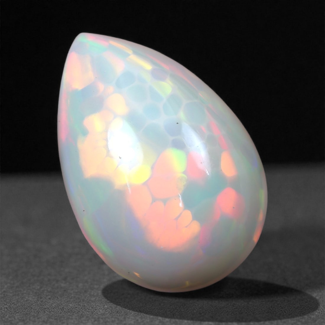 5.31 Carats Honeycomb Welo Opal - Natural Ethiopian Stone 15x10x7.5mm, 4XH: This captivating Welo opal displays a rare and sought-after honeycomb pattern, with vivid flashes of orange, lime green, pink, and gold shimmering across its translucent body. The play-of-color is int