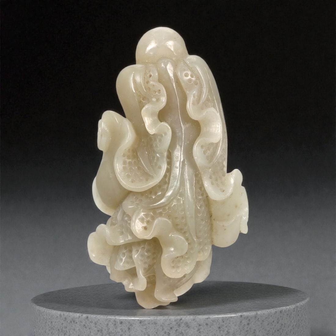 A Chinese Nephrite Jade Cabbage Carving, 20th Century, 32FA: Carved from pale celadon nephrite jade with areas of soft translucency and minor natural inclusions, the object is modeled as a stylized cabbage head. The form is composed of overlapping, curling leav