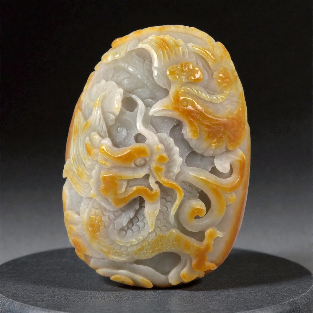 A Chinese Nephrite Jade Dragon and Phoenix Plaque, 20th Century, 3YB: Carved from pale grey-white Hetian nephrite jade with areas of warm russet and golden skin retained and selectively emphasized, the plaque is of rounded rectangular form and worked in high relief with