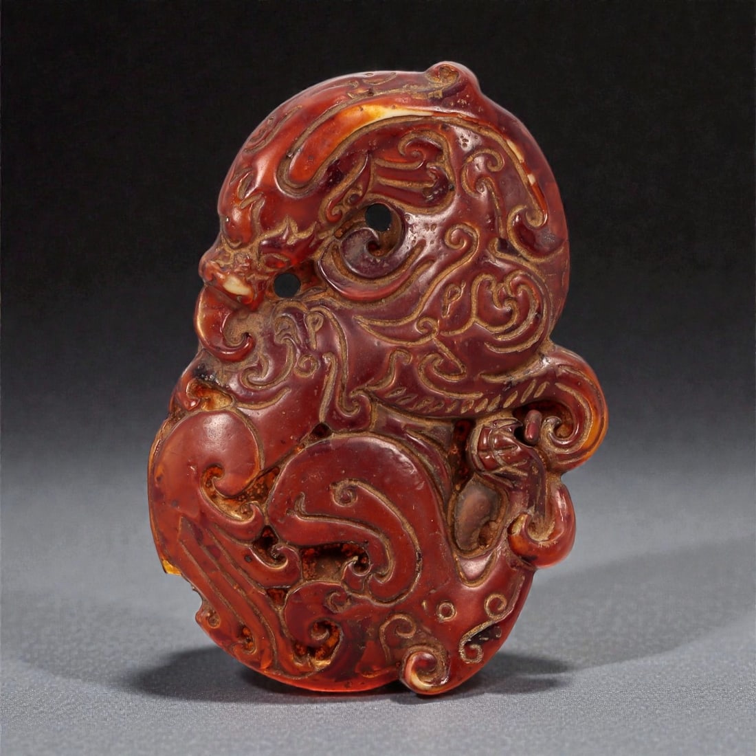 A Chinese Amber-Resin Openwork Plaque with Mask Motif, 20th Century, 90FC (1 of 2)