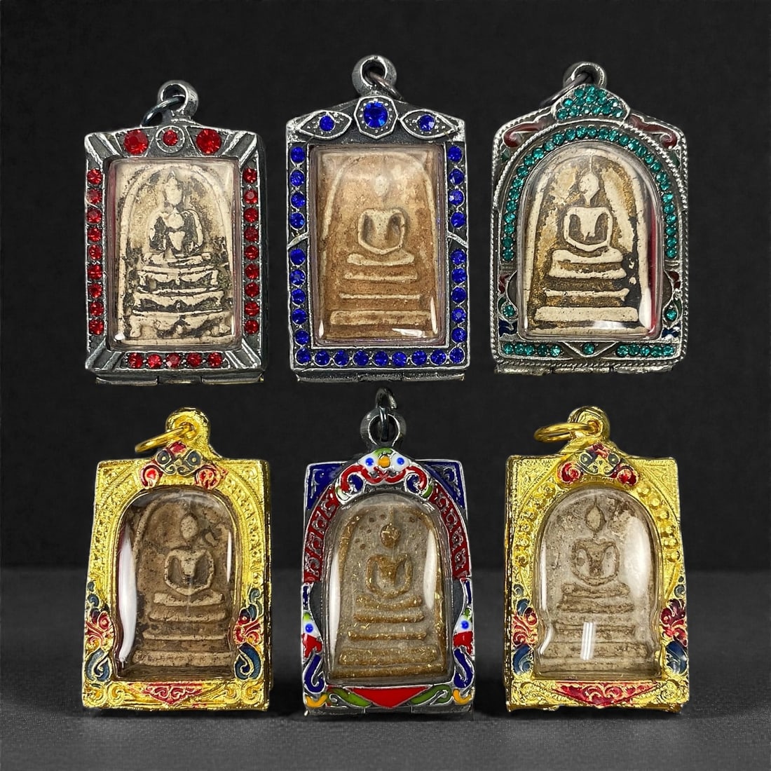 A Group of Six Thai Buddhist Amulets, 20th Century, 10XJ: Comprising six Thai Buddhist amulets formed from pale beige to buff and brown clay-based or composite materials, each molded in shallow relief and depicting a seated Buddha in meditation posture on a