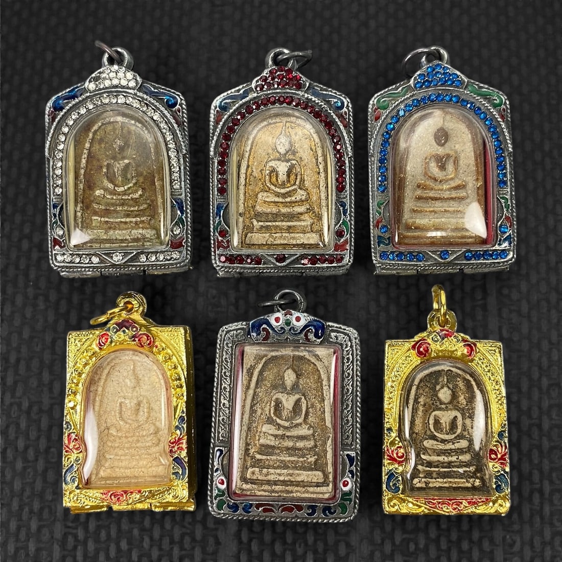 A Group of Six Thai Buddhist Amulets, 20th Century, 25XJ (1 of 2)