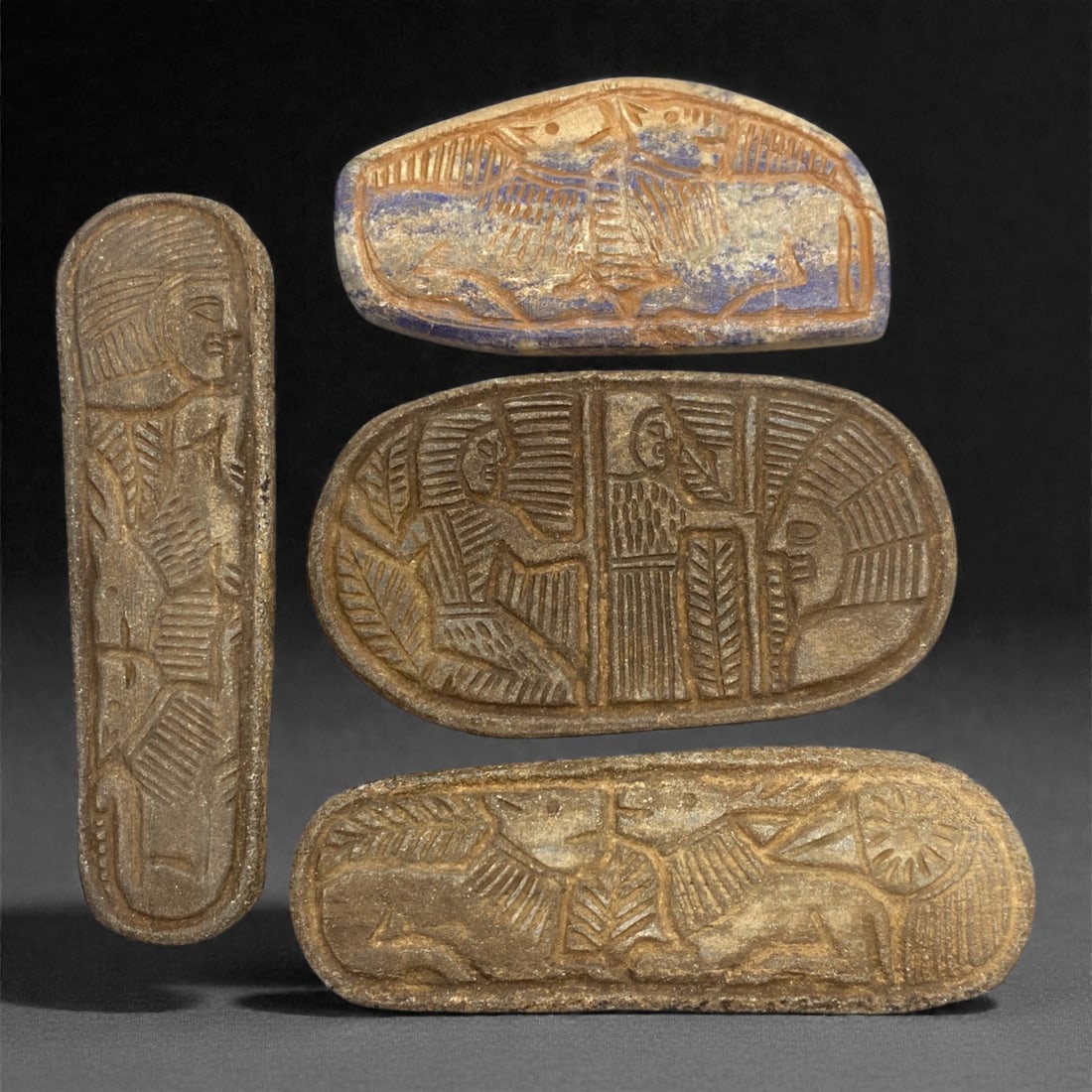 A Sasanian Lapis Lazuli Relief Plaque Group, 3rd-7th Century CE, 96V: Comprising four carved relief plaques of elongated and oval formats, worked in lapis lazuli or lapis-rich stone with visible blue pigmentation and areas of surface wear, the group is executed in shall