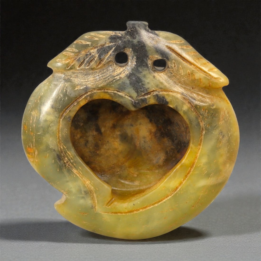 A Chinese Hardstone Miniature Vessel, 20th Century, 34YB: Carved from translucent greenish-yellow hardstone with areas of darker veining and natural inclusions, the vessel is worked in a compact, rounded form with a deeply hollowed interior. The exterior is