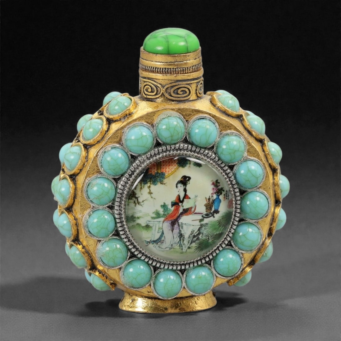 A Chinese Brass-Mounted Snuff Bottle with Figural Insert, 20th Century, 23FG: The bottle is constructed with a flattened circular body encased in a cast brass framework, finished with gilt-toned surfaces and applied ornament. The exterior is extensively set with turquoise-color