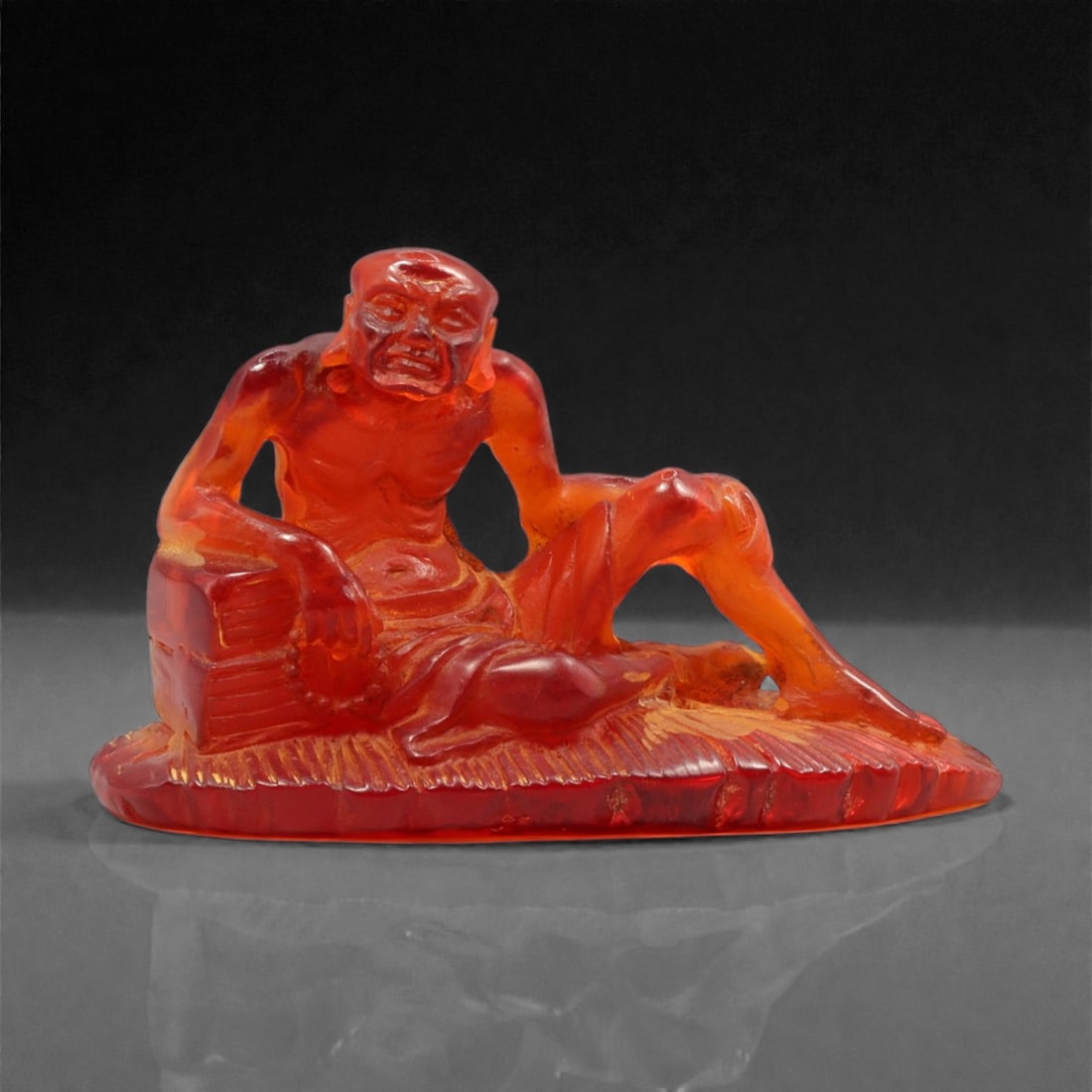 A Chinese Amber-Resin Luohan Figure, 20th Century, 42YC (1 of 2)