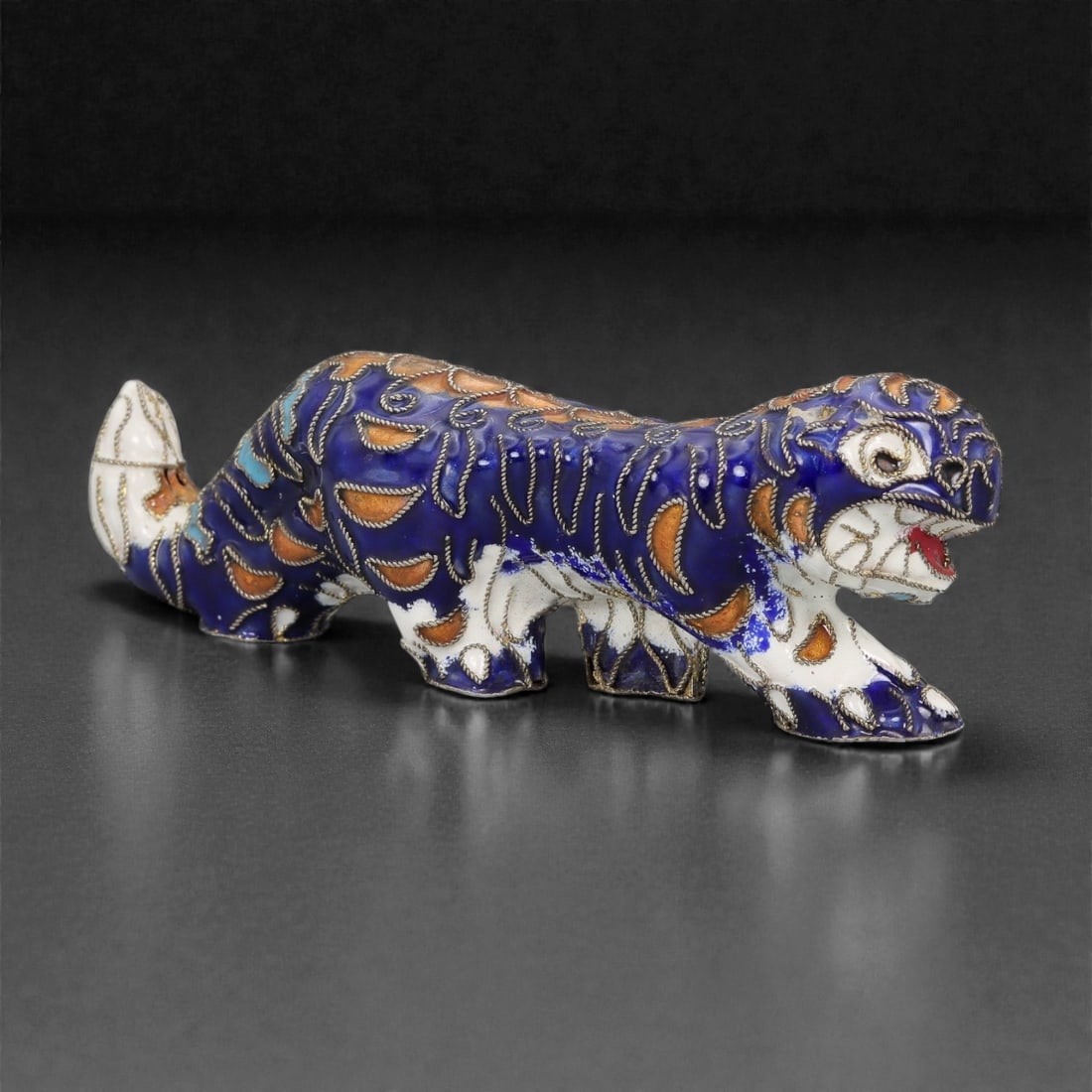 A Chinese Cloisonne Enamel Tiger Effigy, 20th Century, 4FH: Modeled as a striding tiger shown in profile with the body elongated and the head turned slightly forward, the effigy is constructed over a metal core and decorated overall with cloisonne enamel on a