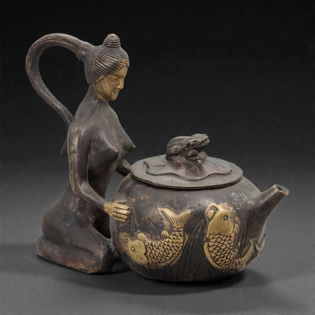 A Chinese Bronze Figural Teapot, Qing Dynasty, 27FH: Cast in bronze as a figural teapot, the vessel is formed with a rounded globular body resting on a flat base, fitted with a short spout and a domed lid surmounted by a sculpted amphibian finial. The h