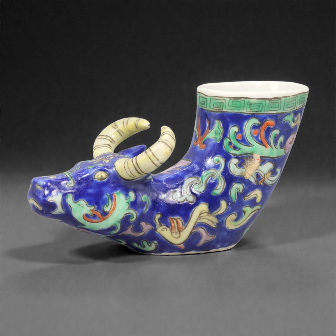 A Chinese Porcelain Bovine-Form Vessel, 20th Century, 85YC: Modeled in porcelain, the vessel is formed as a recumbent bovine with the head turned slightly to one side and the body hollowed to create an open container rising from the back. The animal is depicte