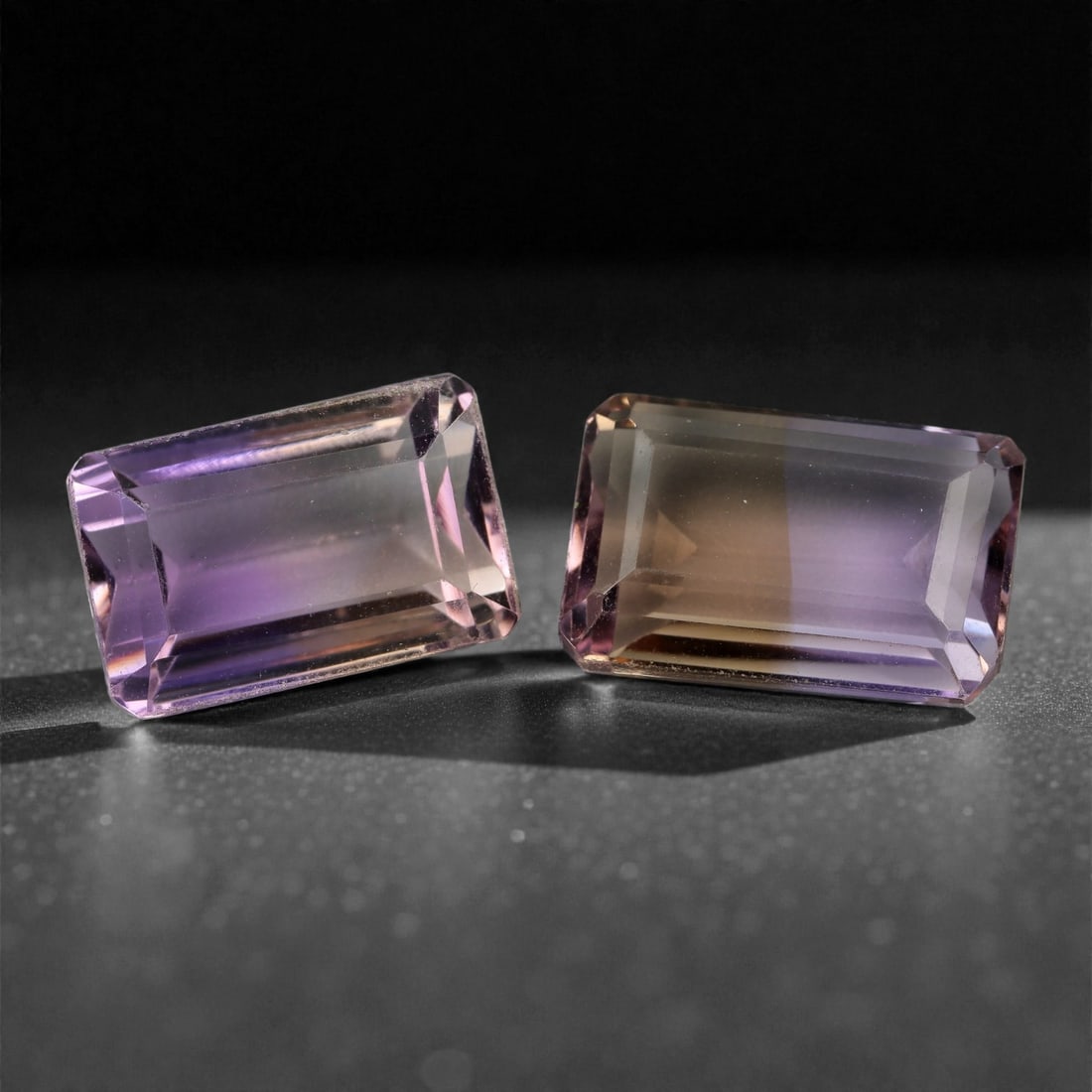27.42 Carats Bicolor Ametrine Pair - Natural Bolivian Stones, 16-17mm, 6XK: This dazzling pair of emerald-cut ametrines captures the rare harmony of golden citrine and rich violet amethyst in a single crystal. With beautifully distinct zoning and mirror-finish faceting, these