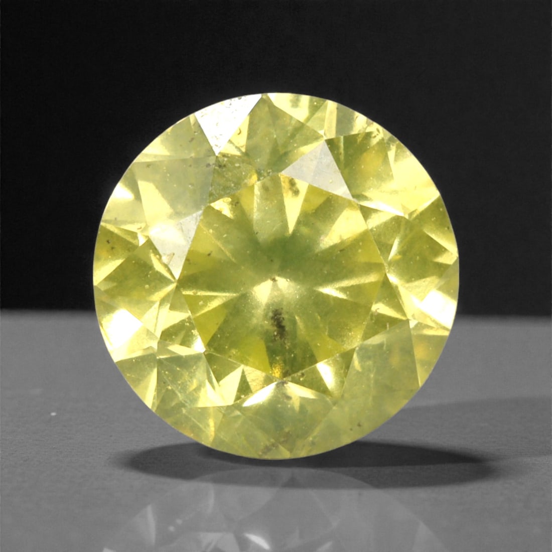 0.50 Carats Fancy Yellow Round Brilliant Diamond - Natural Loose Gemstone, 51DA: This 0.50 carat round brilliant cut diamond captivates with a rich, fancy yellow hue that radiates warmth and vibrancy from every facet. The classic round cut maximizes light return, creating a lively