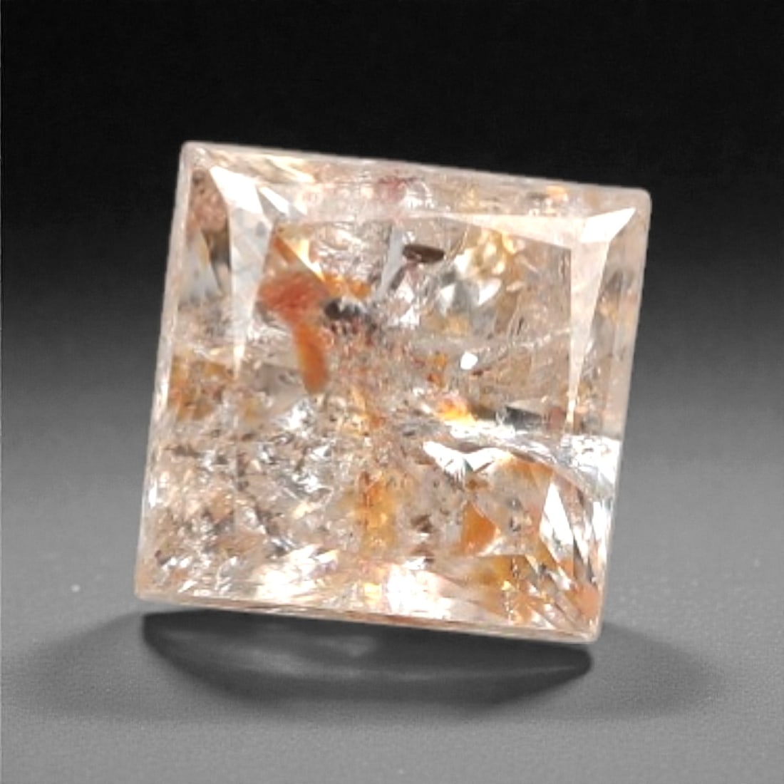 0.15 Carats Fancy Light Brownish Orange Inclusion Diamond - Natural South African Origin, 30DA: This 0.15 carat fancy light brownish orange diamond features a warm, peachy-hued crystal matrix with prominent, naturally occurring internal inclusions, including distinct reddish-brown mineral format