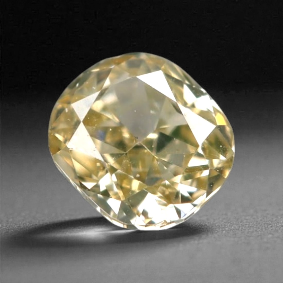 0.20 Carats Fancy Light Yellow Diamond - Natural South African Origin, 16DA: This 0.20 carat fancy light yellow diamond glows with a soft, buttery hue reminiscent of sun-warmed honey, its modified round brilliant cut amplifying a luminous, lively sparkle across every precisely