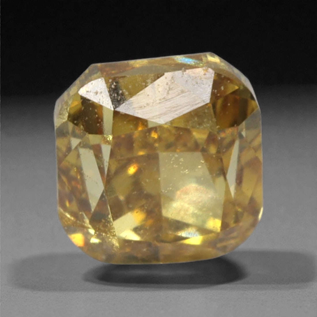 0.22 Carats Fancy Deep Brownish Yellow Diamond - Natural South African Origin, 41DA: This 0.22 carat fancy deep brownish yellow diamond captivates with a rich, earthy hue that evokes the warmth of aged amber and the depth of fine cognac. The cushion modified brilliant cut enhances the
