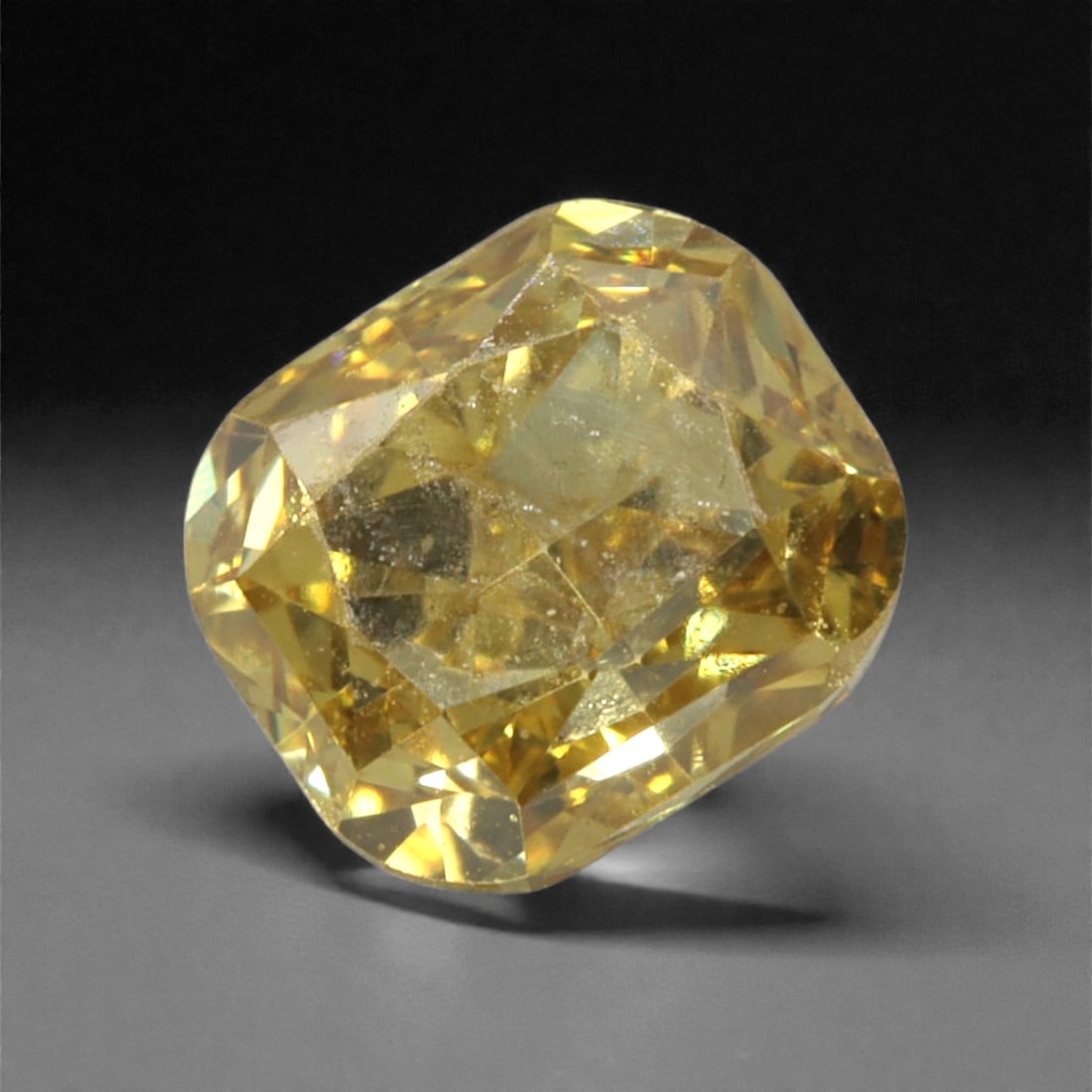 0.26 Carats Fancy Intense Yellow Diamond - Natural South African Origin, 39DA: This 0.26 carat fancy intense yellow diamond dazzles with a rich, saturated canary hue that radiates warmth and vibrancy from every precisely cut facet. The cushion modified brilliant cut enhances the
