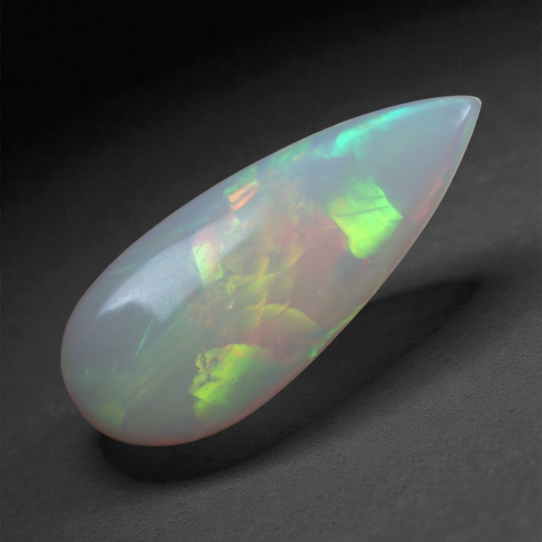 2.70 Carats Play-of-Color Welo Opal - Natural Ethiopian Gem 22x9mm, 40XA: This captivating Welo opal gleams with a luminous cascade of multi neon color that ripple across the stone's surface with every movement. The play-of-color is vivid and well-distributed, presenting a