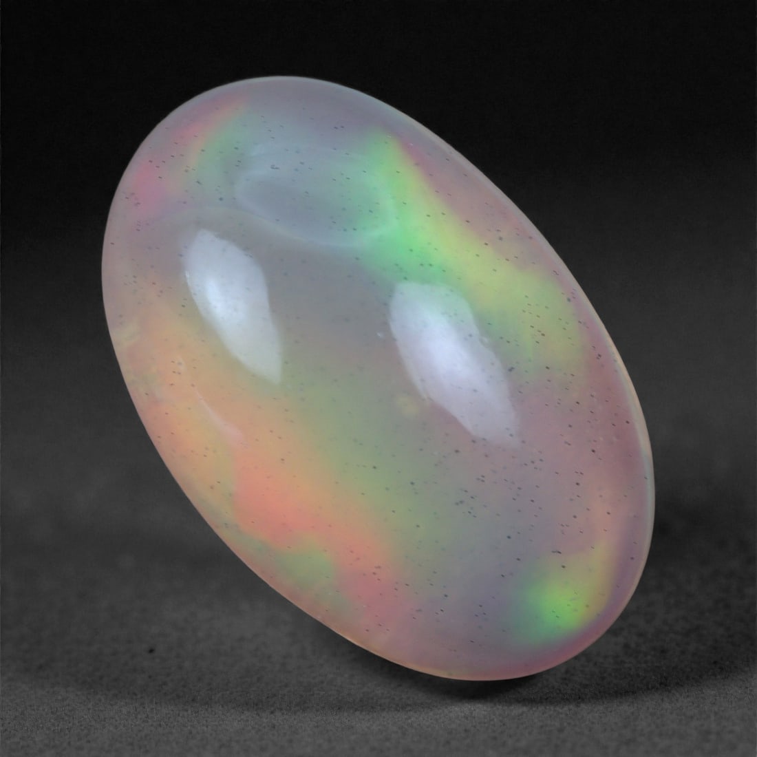 2.61 Carats Play-of-Color Welo Opal - Natural Ethiopian Gem 12x8mm, 94XA: This captivating Welo opal gleams with a luminous cascade of multi neon color that ripple across the stone's surface with every movement. The play-of-color is vivid and well-distributed, presenting a