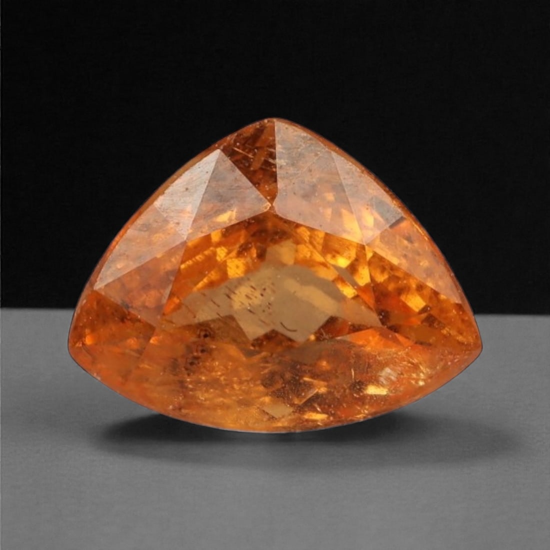1.02 Carats Vivid Orange Fanta Garnet - Natural Tanzanian Stone - 6.6 x 5.0 x 3.7 mm, 31WE: Bursting with vibrant fire, this vivid orange Fanta garnet dazzles with its glowing, sunset-inspired hue. The trilliant cut enhances the stone's brilliance, scattering warm light in every direction an