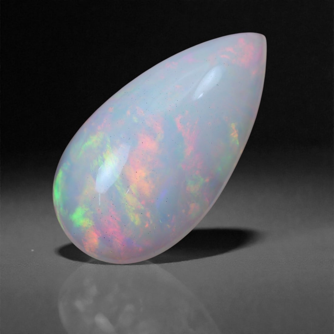 4.18 Carats Fire Garden Welo Opal - Natural Ethiopian Gemstone 17.7x9.6x5.7mm, 33XH: A vivid burst of neon green, cherry red, and golden fire surges through this striking Welo opal, set against a soft, translucent body. The internal pattern is bold and organic-resembling a blooming ga