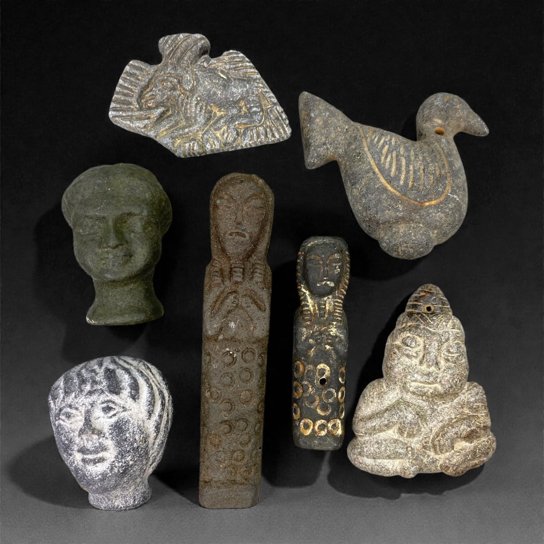 A Near Eastern Schist Amuletic and Figurative Group, Late 3rd-Early 2nd Millennium BCE, 98W: Carved from grey to greenish-grey schist with visible mineral inclusions and areas of surface abrasion, the group comprises seven small amuletic and figurative objects executed in relief and shallow t