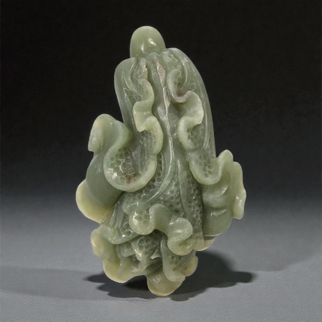 A Chinese Jade Cabbage Carving, 20th Century, 53FB: Carved from pale green jade with areas of soft translucency and subtle yellowish tonal variation, the object is worked in the round and modeled as a leafy cabbage. The composition is vertically orient
