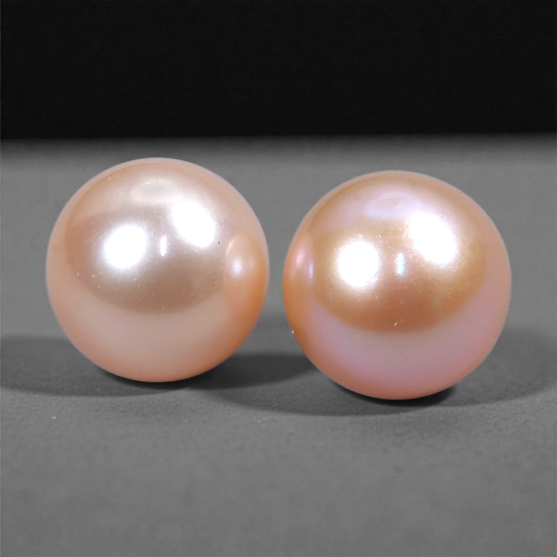 6.82 Carats Warm Peach Pearl Pair - Natural Freshwater Gems, 7mm, 71XH: This graceful pearl pair glows with a warm peach tone, enhanced by soft pink and ivory overtones and excellent surface luster. Their round shape and mirror-like nacre reflect light elegantly, offering