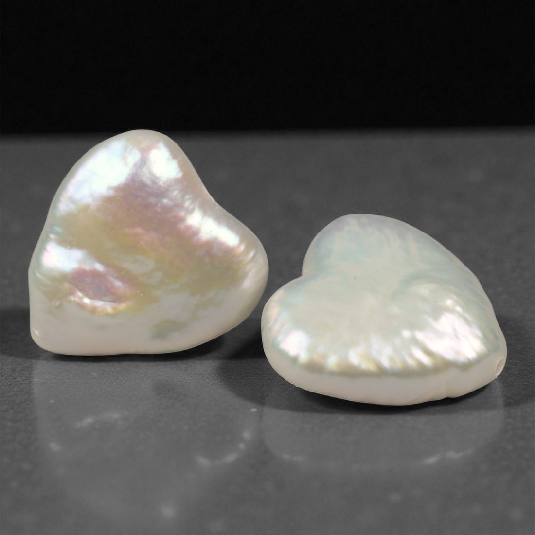 7.20 Carats Iridescent White Heart Pearls - Natural Freshwater - 11.1x10.0x4.3mm, 87WE: This luminous pair of heart-shaped freshwater pearls glows with soft iridescence, showcasing pastel overtones of rose, lavender, and pale green across a creamy white base. Their organic surface textur