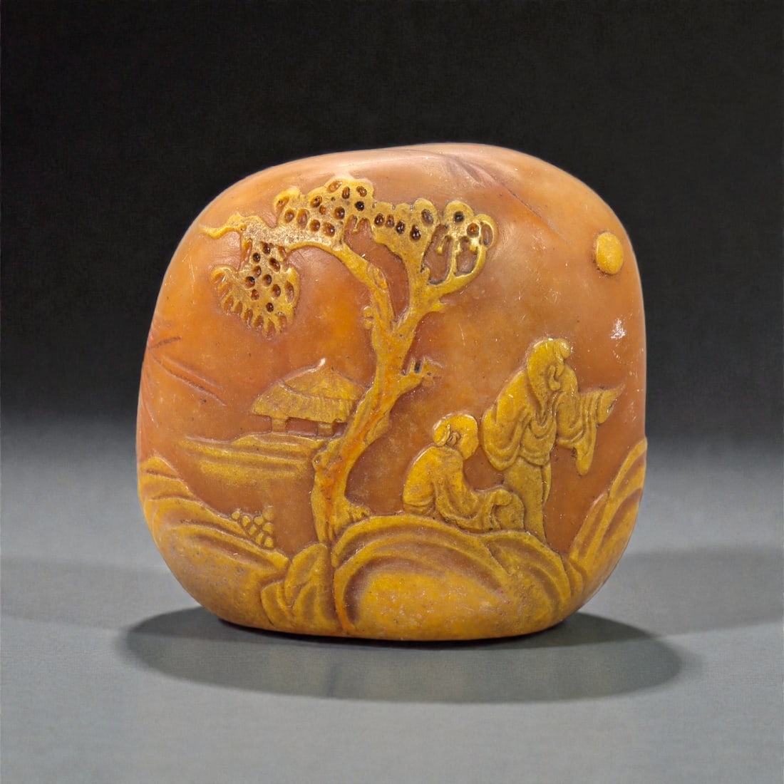 A Chinese Songshan Stone Seal, 20th Century, 11FA: Carved from warm-toned Songshan stone with natural mottling and subtle tonal variation, the seal is squat and rounded in form, with softly curved sides and a flat engraved base. The exterior is worked