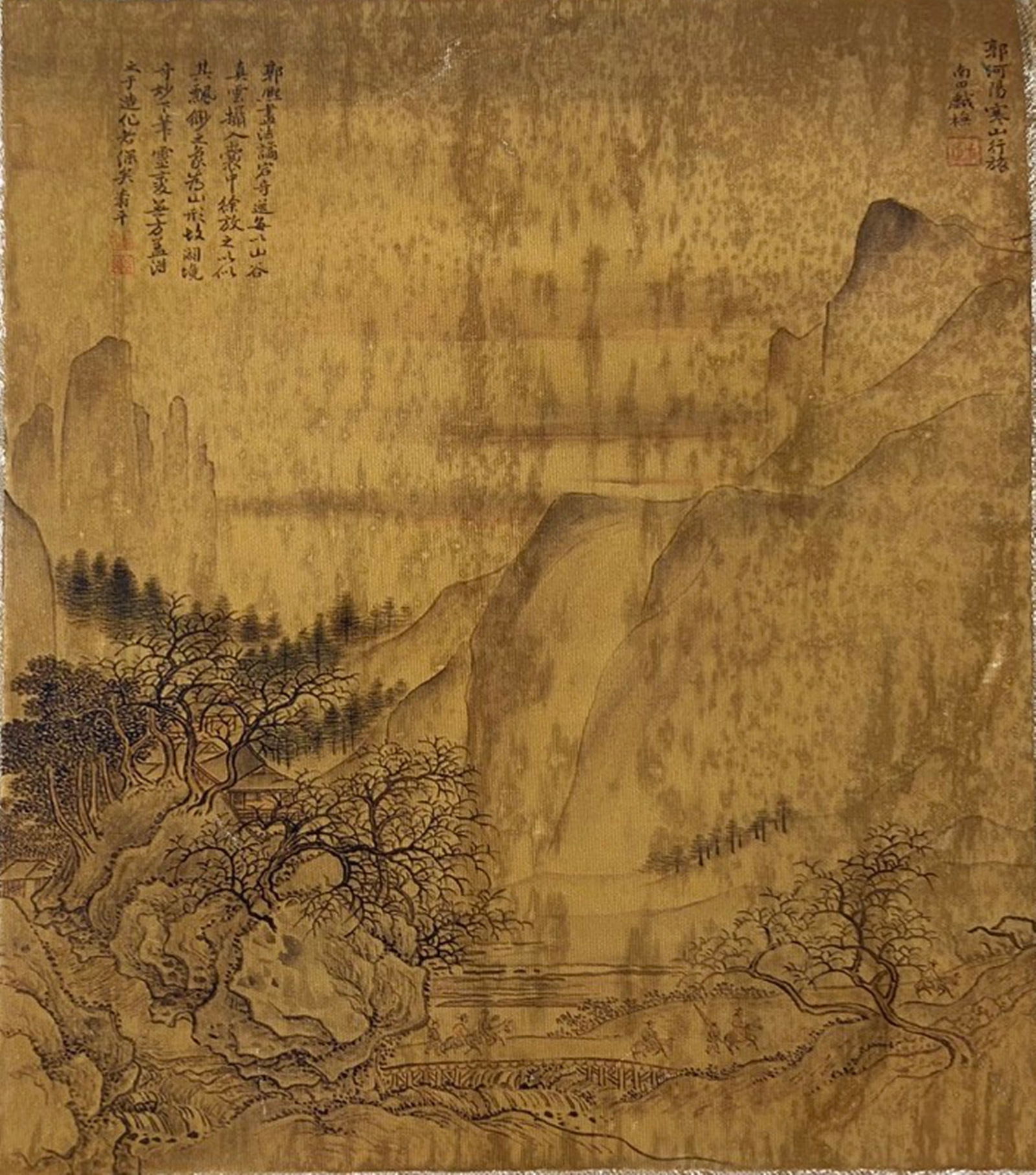 A Chinese Ink and Color Textile Print, Traveling in a Wintry Mountain, 20th Century, 93FJ: Printed on woven silk or hemp textile with a gold-toned ground, the composition depicts a sparse winter landscape in the style of Northern Song painter Guo Xi. Bare, twisted trees cling to rocky outcr