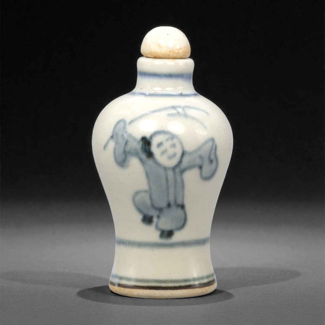 A Chinese Porcelain Snuff Bottle, Qing Dynasty, 62YC: The bottle is formed from white porcelain with a translucent glaze, painted in underglaze cobalt blue. It has a baluster body rising from a flat foot to a short cylindrical neck with a recessed mouth,