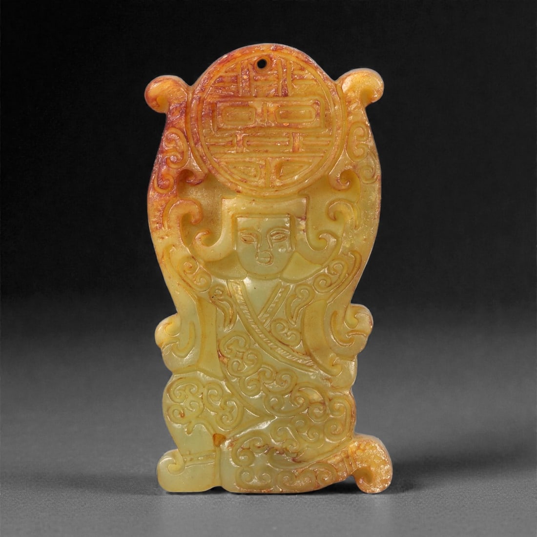 A Chinese Archaistic-Style Hetian Jade Plaque, 20th Century, 55FH: Carved from pale yellow-green Hetian jade with areas of russet staining and natural inclusions, the plaque is rectangular in form with rounded projecting terminals and shallow relief decoration. The u