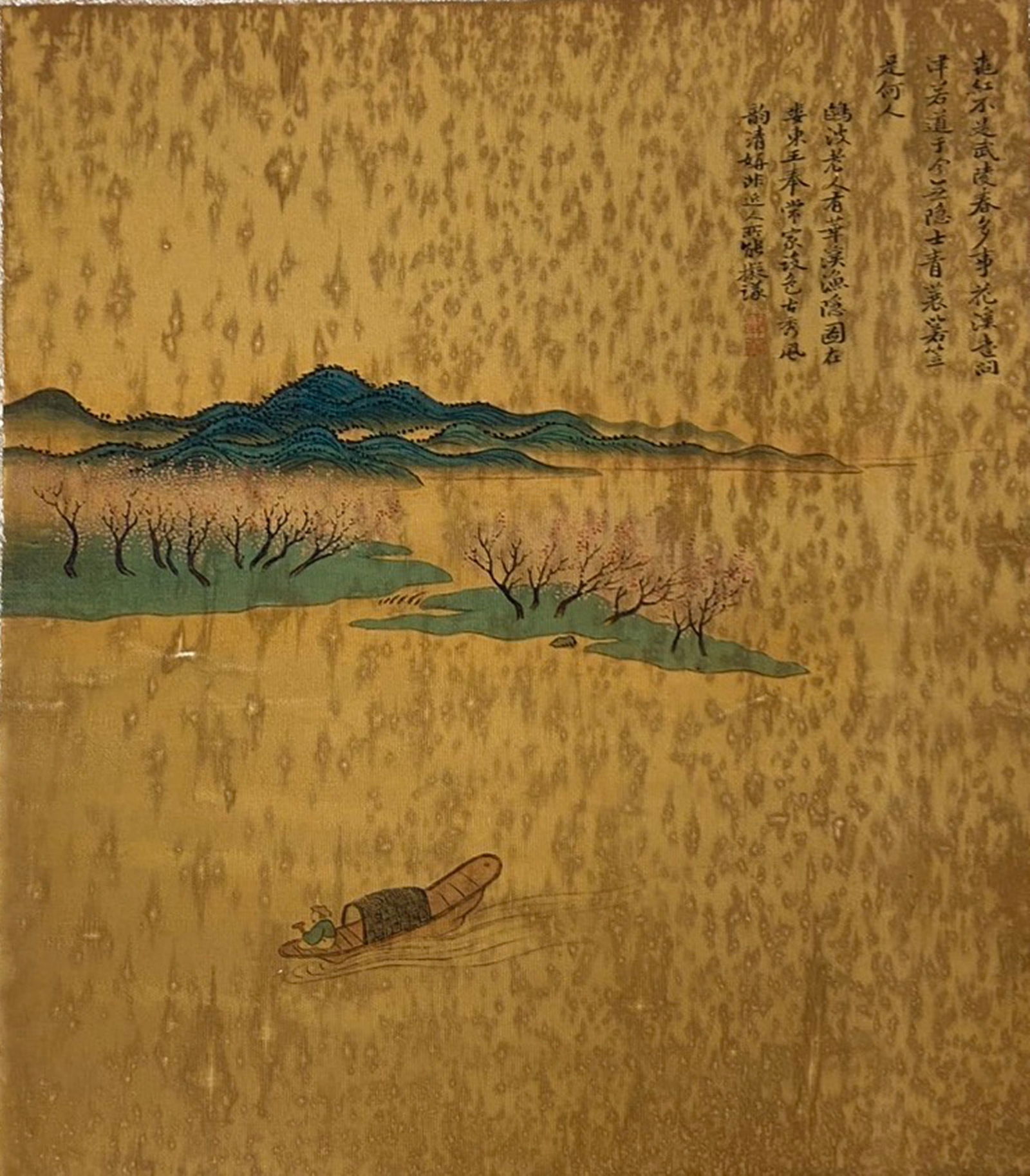 A Chinese Ink and Color Textile Print, Peach Blossom Spring, 20th Century, 99FJ: Printed on woven silk or hemp textile with a gold-toned ground, the composition depicts the idyllic scene of Peach Blossom Spring, inspired by the classic Chinese fable. A solitary fisherman drifts in