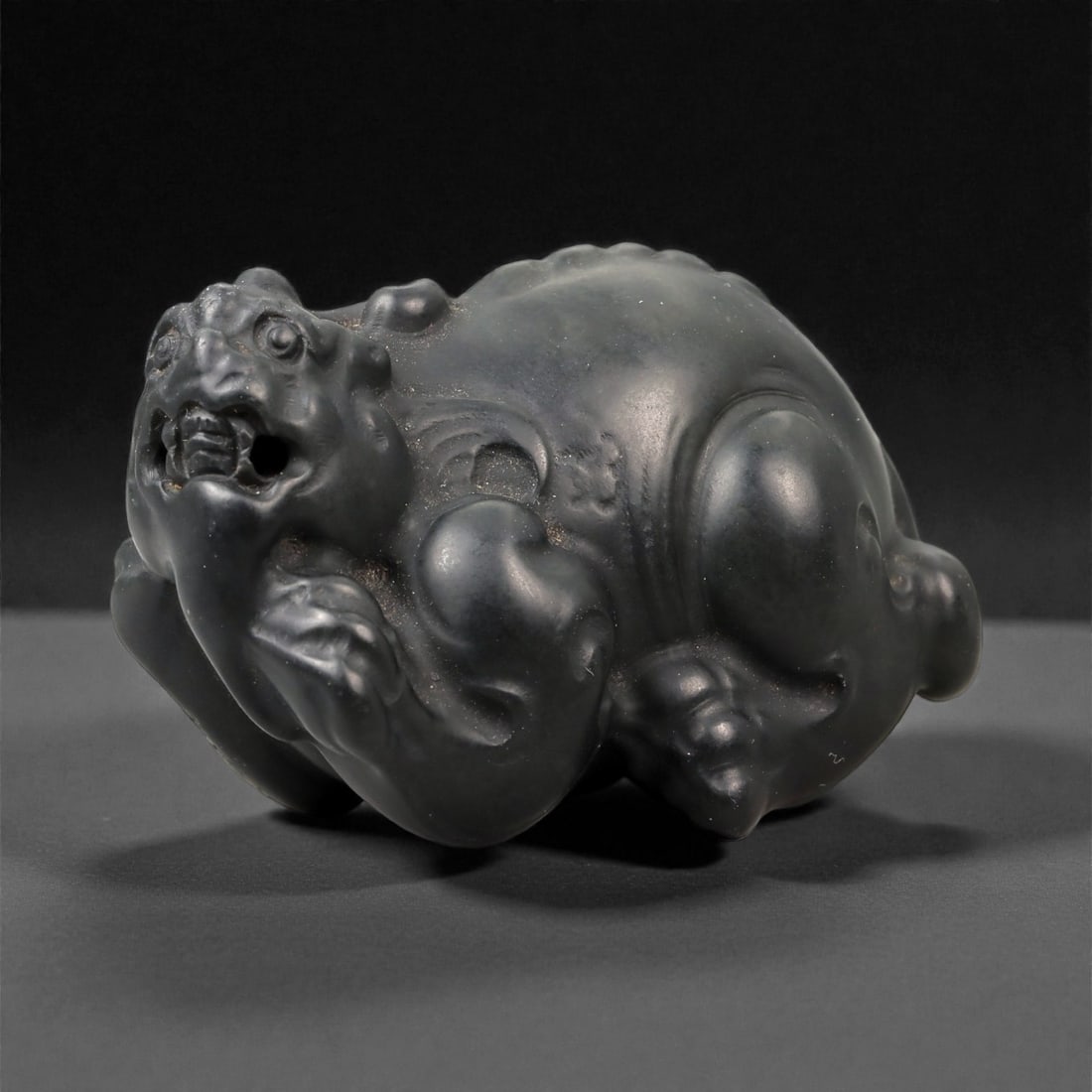 Chinese Jade Mythical Beast - Carved Animal Figurine 4.7cm, 98ZC: Carved from dark green to nearly black jade with a dense, even tone and minimal translucency, this compact sculpture represents a stylized mythical beast rendered in a recumbent posture. The carving i