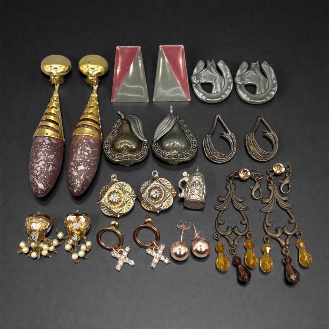 An Estate Lot of Ten Pairs of Earrings and One Brooch, Late 20th Century, 89FK: The lot comprises ten pairs of earrings and one brooch, crafted from varied metals including gilt, silver-toned alloy, and brass, with enamel, composite stone, and glass accents. The earrings exhibit