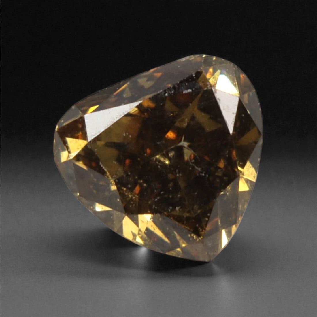 0.17 Carats Fancy Deep Brownish Yellow Diamond - Natural South African Origin, 37DA: This 0.17 carat fancy deep brownish yellow diamond captivates with a rich, earthy hue that evokes the warmth of aged amber and the depth of fine cognac. The heart-shaped cut enhances the stone's natur