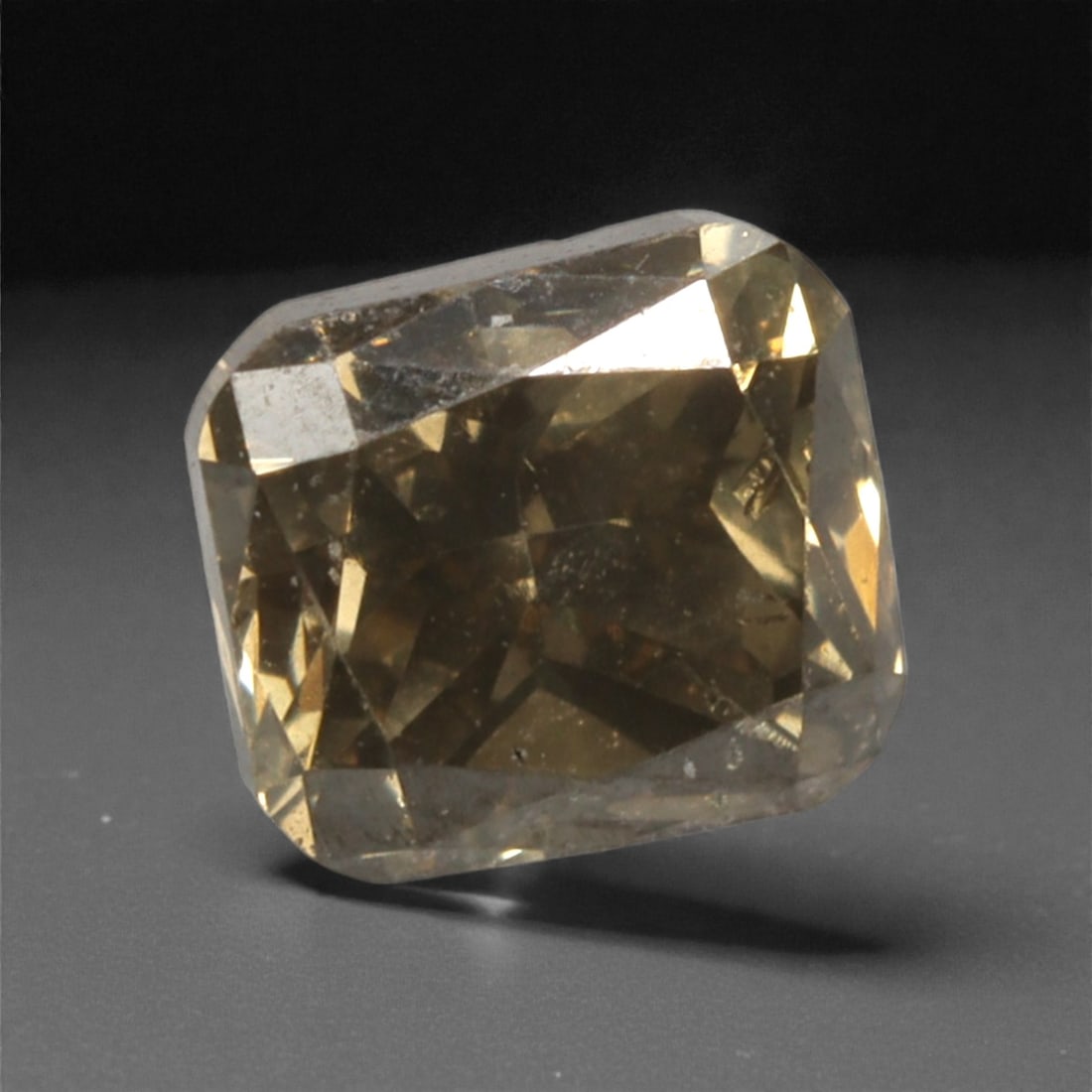 0.26 Carats Fancy Light Brownish Yellow Diamond - Natural South African Origin, 38DA: This 0.26 carat fancy light brownish yellow diamond exudes a warm, honeyed glow, with a subtle champagne undertone that lends it a sophisticated, understated elegance. The radiant cut enhances the sto