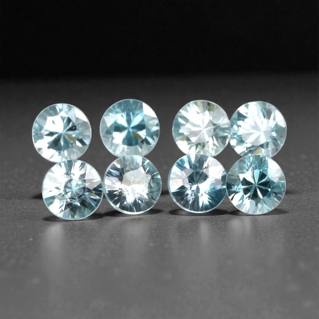 3.29 Carats Sky Blue Zircon Selection - Natural Cambodian Stones, 374A: This curated selection of eight round-cut zircon gems presents a serene, sky-blue hue, reminiscent of clear tropical waters and open summer skies. Each stone is precision-faceted to maximize light dis