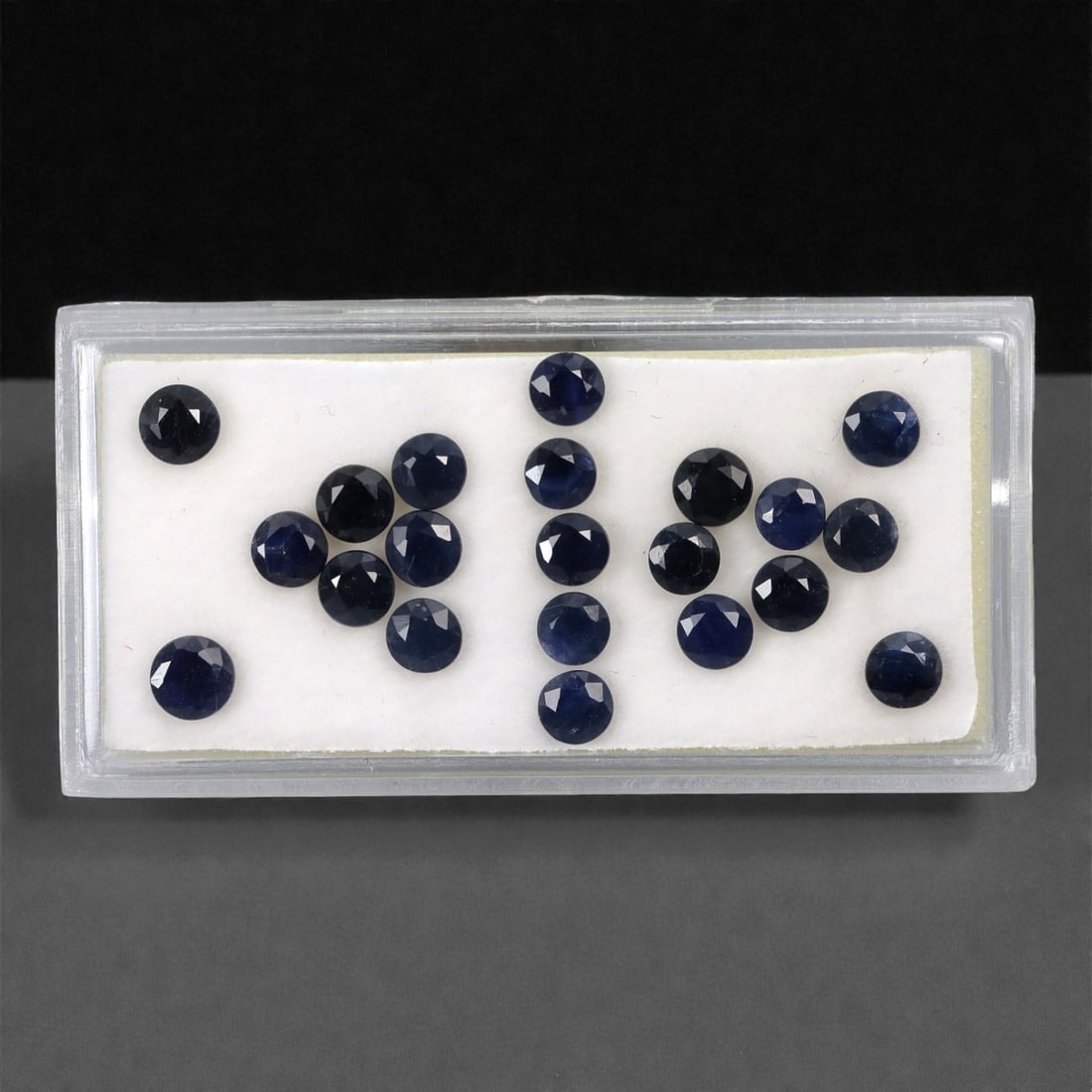 6.30 Carats Australian Blue Sapphire Parcel - Round Brilliant Cut, 66DA: This curated parcel of round brilliant-cut blue sapphires from Australia exhibits a rich, deep blue hue, reminiscent of the ocean at midnight. Each stone is precision-cut to maximize light return, cre