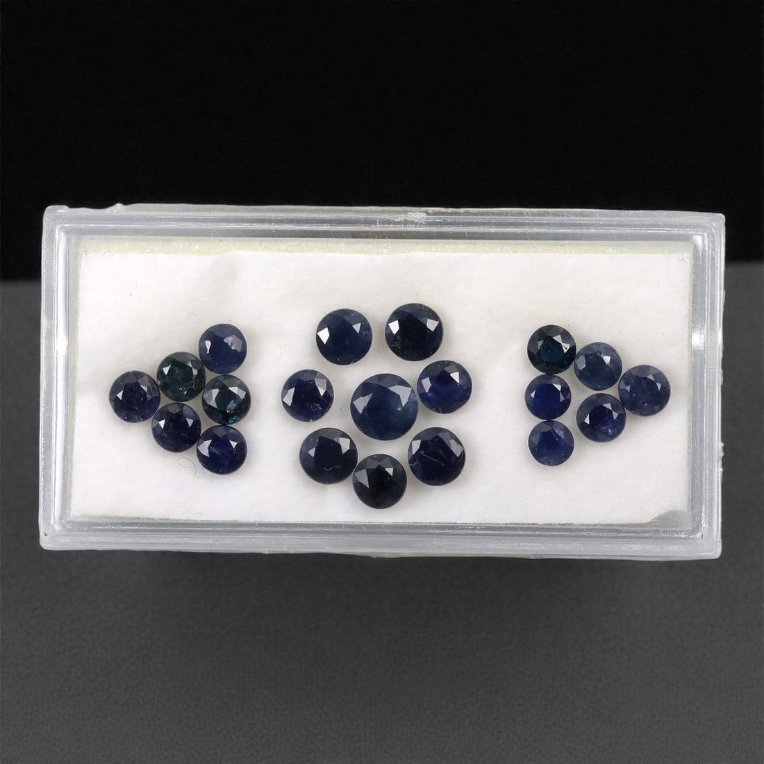 6.24 Carats Australian Blue Sapphire Parcel - Round Brilliant Cut, 67DA: This curated parcel of round brilliant-cut blue sapphires from Australia exhibits a rich, deep blue hue, reminiscent of the ocean at midnight. Each stone is precision-cut to maximize light return, cre