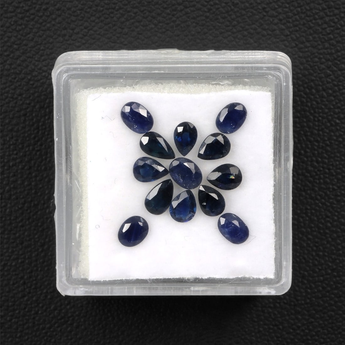 2.94 Carats Australian Blue Sapphire Parcel - Pear & Oval Cut, 86DA: This curated parcel of pear and oval-cut blue sapphires from Australia exhibits a rich, deep blue hue, reminiscent of the ocean at midnight. Each stone is precision-cut to maximize light return, creat