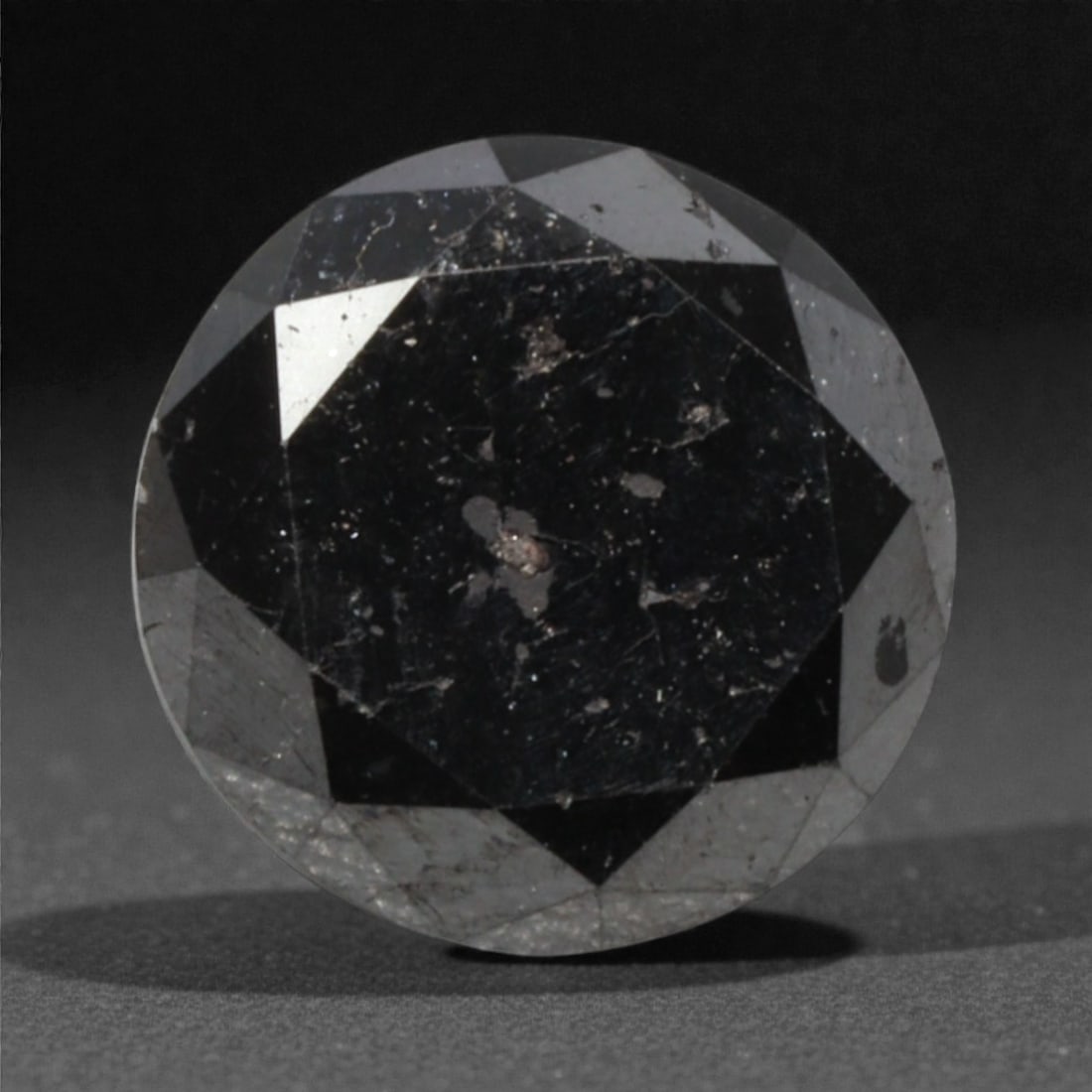 1.40 Carats Black Diamond - Round Brilliant Cut, 294A: This substantial black diamond captivates with a deep, opaque black hue that evokes the intensity of polished obsidian and the mystery of a midnight sky. Cut in a well-proportioned round brilliant sha