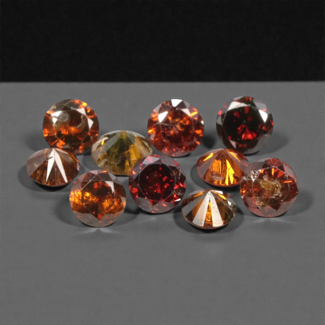 10 Pieces Irradiated Red Diamond Parcel - Round Brilliant Cut, 1.6-1.7mm, 271A: This vibrant parcel of 10 loose irradiated red diamond gems captivates with a rich, fiery red hue that evokes the intensity of a glowing ember and the warmth of a sunset. Each stone is cut in a well-p