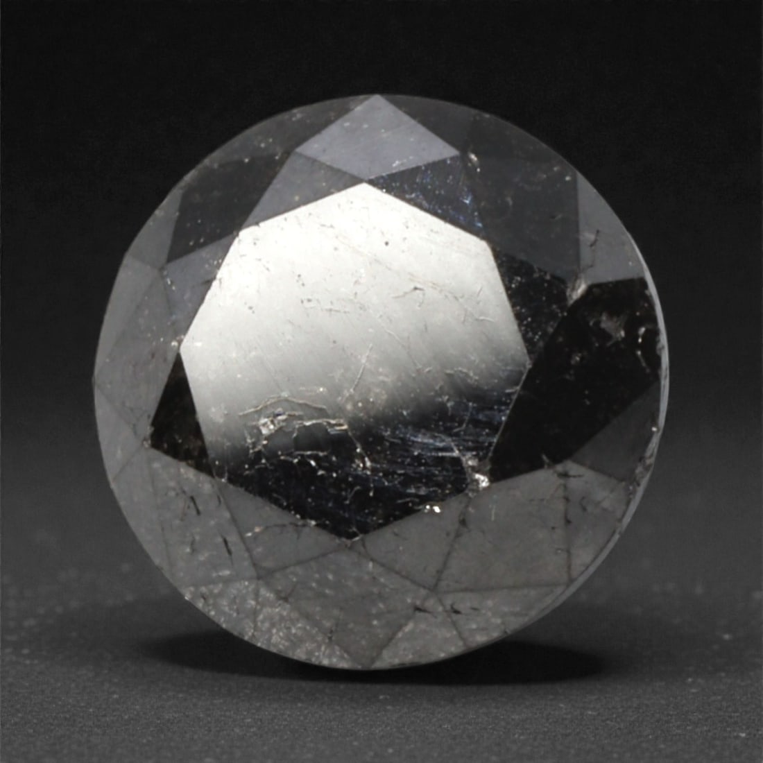 2.22 Carats Black Diamond - Round Brilliant Cut, 300A: This substantial black diamond captivates with a deep, opaque black hue that evokes the intensity of polished obsidian and the mystery of a midnight sky. Cut in a well-proportioned round brilliant sha